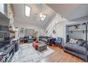 Bright living room boasts high ceilings, a stone fireplace, hardwood floors, and plenty of natural light at 2552 Spring Hill Ct, Indianapolis, IN 46268