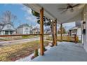 View from the front porch, showcasing natural wood columns and updated railing with a view of the street at 2626 E 18Th St, Indianapolis, IN 46218