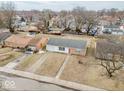 Aerial view of a single story home with a driveway and a bright red front door at 2714 Manlove Ave, Indianapolis, IN 46218
