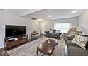 Cozy living room with dark wood floors, plush seating, and ample natural light at 2879 Bluewood Way, Plainfield, IN 46168