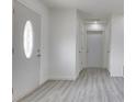 Spacious living room with light gray flooring and white walls at 32 Downing Dr, Trafalgar, IN 46181