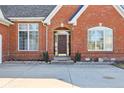Beautiful brick home featuring an arched front door with manicured shrubbery at 351 Mallard Ct, Carmel, IN 46032