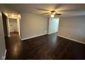 Spacious room with wood flooring, views to the utility room, and modern ceiling fan at 3837 Candle Berry Dr, Indianapolis, IN 46235