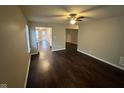Bright living room with ceiling fan and view into the kitchen with wood flooring at 3837 Candle Berry Dr, Indianapolis, IN 46235