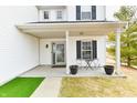A covered front porch includes a small table and chair set at 3873 Crest Point Dr, Noblesville, IN 46062