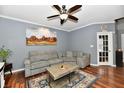 Comfortable living room with a gray sofa, ceiling fan, and decorative rug at 3873 Crest Point Dr, Noblesville, IN 46062