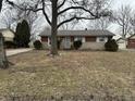 Traditional brick home featuring an attached garage and well-maintained landscaping at 4616 N Kenmore Rd, Indianapolis, IN 46226