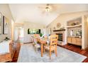 Elegant dining room with a fireplace, built-in fish tank and a large table set for a gathering at 5079 Stonespring Way, Anderson, IN 46012