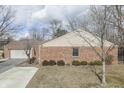 Lovely brick ranch home with attached garage, mature trees and manicured landscaping at 8225 S East St, Indianapolis, IN 46227
