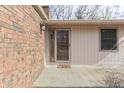 Inviting front entrance with a 'Game On' doormat, brick accents, and sidelight window at 8225 S East St, Indianapolis, IN 46227