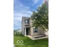 Inviting home with a well-manicured lawn, complemented by a lush green tree at 8249 Retreat Ln, Indianapolis, IN 46259