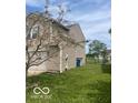 Tan home featuring a well-maintained lawn, showcasing its outdoor space at 8249 Retreat Ln, Indianapolis, IN 46259