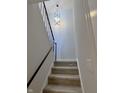 A well-lit stairway with modern black railing and new carpet leads to the upper level at 8315 Woodall Dr, Indianapolis, IN 46268
