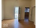 Bright living room with hardwood floors featuring view of entrance, windows and doors at 905 N Sheffield Ave, Indianapolis, IN 46222
