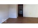 Neutral room featuring wood look floors and a doorway leading to appliances at 905 N Sheffield Ave, Indianapolis, IN 46222