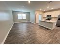 Spacious living area open to the kitchen, featuring stainless steel appliances and wood-look floors at 9616 Beckett St, Avon, IN 46123