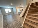 Bright living area featuring modern flooring, natural light, and stairs leading to the upper level at 9616 Beckett St, Avon, IN 46123