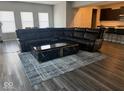 Living room with hardwood floors, a large sofa, and a stylish coffee table at 10218 Cliff Ln, Indianapolis, IN 46239