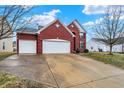 Well-kept two-story brick home with a large two-car garage and an expansive concrete driveway at 11185 Beardsley Way, Fishers, IN 46038