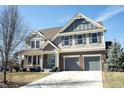 Two-story home featuring a two-car garage, brick accents, and a well-manicured lawn at 12650 Misty Ridge Ct, Fishers, IN 46037