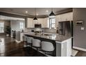 Bright kitchen featuring a large island with seating, stainless steel appliances, and ample counter space at 13306 Saxony W Blvd, Fishers, IN 46037