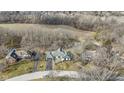 Aerial view of the property showcasing its location nestled amongst trees in a quiet neighborhood at 140 Raintree Dr, Zionsville, IN 46077