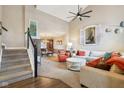 Inviting living room features vaulted ceilings, a cozy seating area, staircase, and seamless flow into the dining area at 1542 Waterford Dr, Zionsville, IN 46077