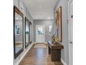 Inviting entryway boasts hardwood floors, decorative mirrors, console table, and neutral paint at 16917 Sandhurst Pl, Westfield, IN 46074
