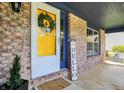 Inviting front porch with brick accents, yellow door, and cozy decor at 17420 Dalton Ct, Noblesville, IN 46062