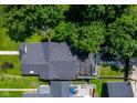 Aerial view showcases a rooftop deck with seating, a fire pit, and lush green surroundings at 1818 N Cornell Ave, Indianapolis, IN 46202