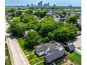 Aerial view of a home nestled among lush greenery with the downtown city skyline in the distance at 1818 N Cornell Ave, Indianapolis, IN 46202