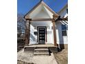Close up of the home's covered porch with a modern black front door at 1818 N Cornell Ave, Indianapolis, IN 46202