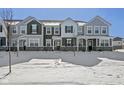 A row of modern townhouses in winter with snow-covered yards and architectural details at 2061 W 171St St, Westfield, IN 46074