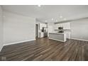 Spacious open-concept living area with hardwood floors and a modern kitchen with stainless steel appliances at 2061 W 171St St, Westfield, IN 46074