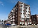Classic brick apartment building with white accents and a neatly maintained parking area at 230 E 9Th St # 506, Indianapolis, IN 46204