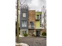 Modern home showcasing unique architecture with a mix of stone, gray, and green exterior finishes at 2417 E 80Th E St, Indianapolis, IN 46240