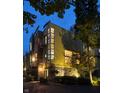 Evening shot of a unique contemporary home with yellow stucco and lots of light at 2417 E 80Th E St, Indianapolis, IN 46240