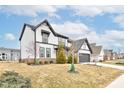 Side view of a lovely two-story home with a manicured lawn and a two-car garage at 3567 Snowdon Dr, Westfield, IN 46074