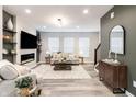 Bright living room with an electric fireplace, plush seating, and a stylish accent cabinet at 4321 Barrel Ln, Westfield, IN 46062
