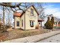 Side view of a yellow two-story home with a red roof surrounded by trees at 462 W Broadway St, Greenwood, IN 46142