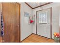 Inviting entryway with hardwood floors, coat hooks, a wooden door and transom window at 477 S Restin Rd, Greenwood, IN 46142