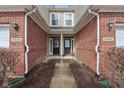 Close-up view of the entrance of two townhomes, showcasing brickwork and well-maintained front doors at 5682 Castor Way, Noblesville, IN 46062