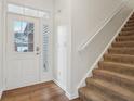 Bright foyer with hardwood flooring, a staircase, and a front door with sidelights at 5682 Castor Way, Noblesville, IN 46062
