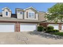 Charming townhouse showcasing attached garages, and manicured landscaping at 5682 Castor Way, Noblesville, IN 46062