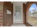 Close-up of the front door showcasing brickwork and architectural details at 5814 Beechwood Ave, Indianapolis, IN 46219