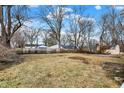 Spacious backyard with mature trees, a well-maintained lawn, and plenty of room for outdoor activities at 6104 Gifford St, Indianapolis, IN 46228