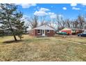 Well-maintained brick home with a nice lawn, beautiful landscaping, and a driveway with ample parking space at 6104 Gifford St, Indianapolis, IN 46228
