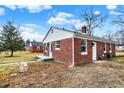 Charming brick home featuring mature trees, a well-maintained lawn, and a welcoming entrance at 6104 Gifford St, Indianapolis, IN 46228