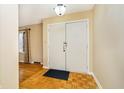 Entryway with hardwood floors, neutral walls, and a coat closet at 647 Mulford Ct, Indianapolis, IN 46234