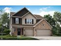 Charming two-story home with a brick and siding exterior, an attached two-car garage, and a well-maintained lawn at 7231 Estes Dr, Indianapolis, IN 46239